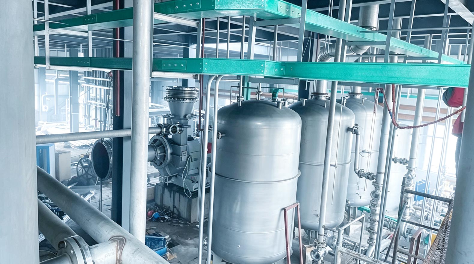 Industrial facility with large metal storage tanks and piping